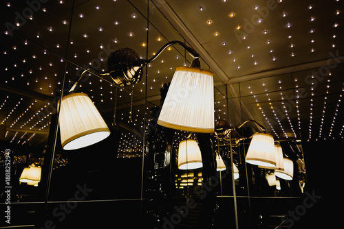 Wallpaper Mural Glowing lamp shades under dotted ceiling reflect in mirrors creating cozy evening ambience indoors Torontodigital.ca