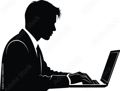 Silhouette of a businessman working on a laptop computer