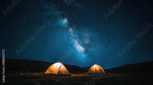 Two tents glow under the night sky filled with stars and the Milky Way. A perfect scene for campers and stargazers alike.