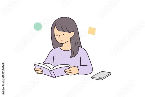 Asian female teen reading a book with phone nearby