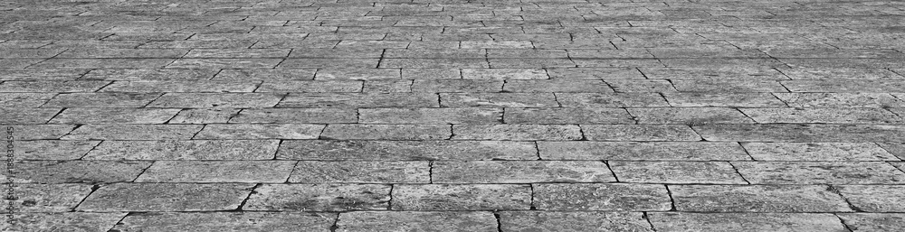 Fototapeta premium Old stone pavement background used for vintage city street textures, urban Perspective concrete block pavement. City sidewalk block or the pattern of stone block paving Empty floor in perspective view