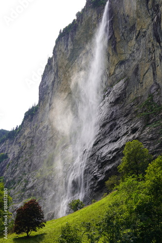 Powerful waterfall cascading down cliff in Lauterbrunnen valley, Switzerland