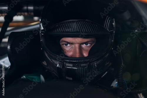 Racing Driver in Carbon Fiber Helmet Sitting Inside Race Car Cockpit During Track Day