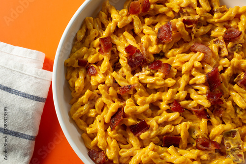 A top down view of a plate of dairy-free, gluten-free bacon mac n cheese bacon, using gemelli pasta.