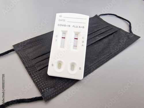 COVID-19 and Influenza A+B rapid test kit on protective face mask