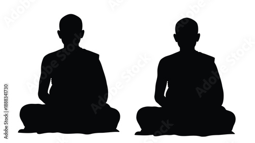 Two men in seated meditation pose a striking black silhouette