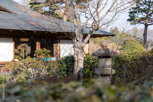 Fotografie Traditional Japanese garden with wooden house and natural landscaping