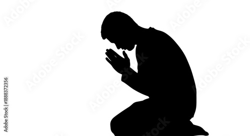 A person kneels in prayer with hands clasped in a moment of solitude