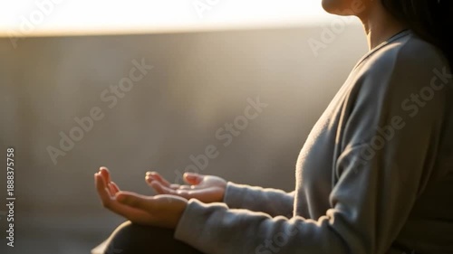 A serene woman practices meditation in a surreal environment with her hands in a peaceful gesture.
