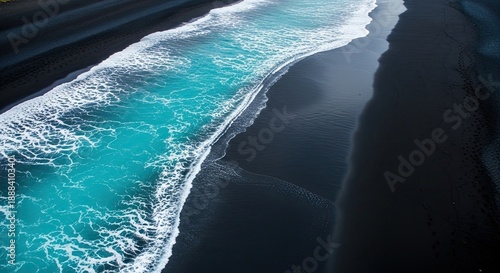 Turquoise waves on black sand beach