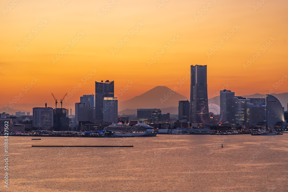 Obraz premium 横濱ベイブリッジ展望台から夕景のみなとみらいと富士山を閉経に出港する豪華客船