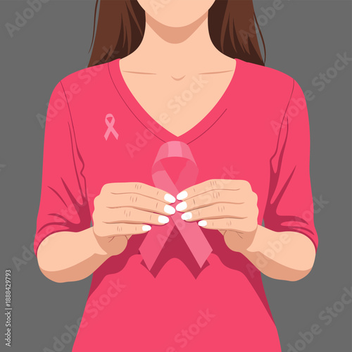 Woman holding pink breast cancer awareness ribbon.