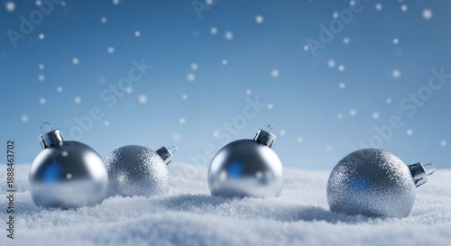 Silver ornaments in a snowy landscape with falling snowflakes