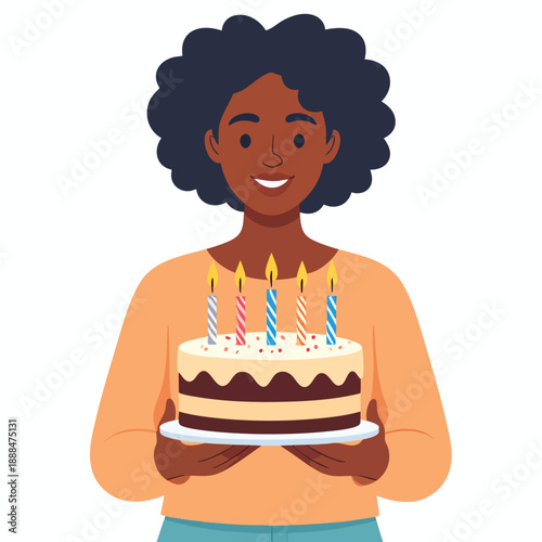 A young woman holding a birthday cake with lit candles in her hands