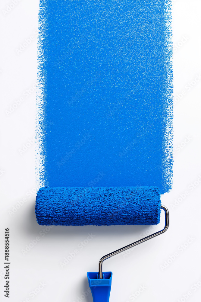 Obraz premium Top view of a paint roller applying a vertical stripe of blue paint on a white surface