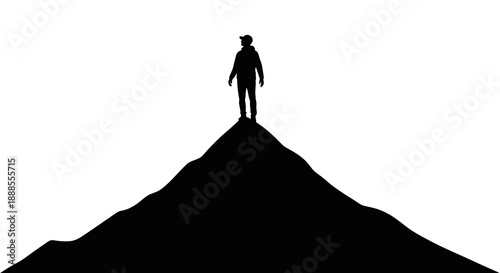 Silhouette of a lone hiker standing atop a mountain peak symbolizing achievement and success with