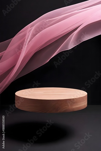 Elegant wooden podium with flowing pink fabric against a dark background, perfect for product display and showcasing