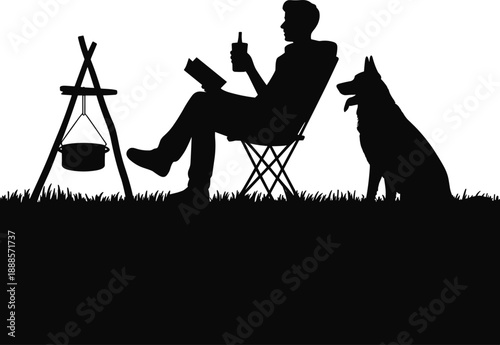 Silhouette of a man enjoying a drink and reading a book while camping with his dog next to a campfire