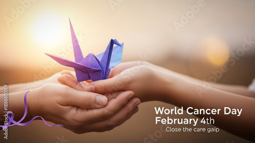 Hands holding purple origami crane for world cancer day on february 4th with sunset background