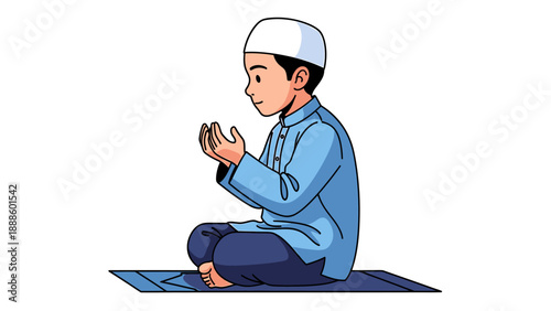 Young Muslim boy praying on a prayer mat.