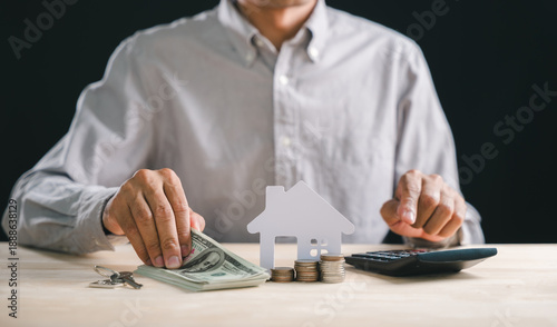 Canvastavla Person calculates home loan interest rate and mortgage payments, arranging dolla