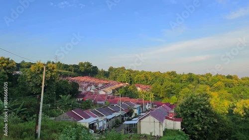 Wallpaper Mural Rows of identical houses with red roofs situated on a lush green hillside slope. Torontodigital.ca