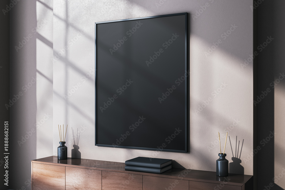 Obraz premium Vertical black blank poster frame on wall in modern interior room with sunlight and shadow creating artistic display background concept. 3D Rendering