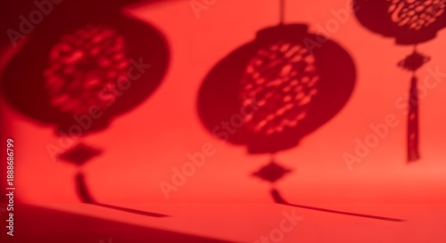 Intricate shadows of traditional decorative lanterns cast upon a vibrant crimson wall, evoking a sense of festive celebration and cultural heritage with delicate patterns