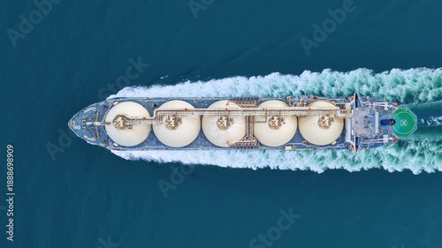 LNG tanker ship sailing in the open ocean. Liquefied Natural Gas carrier vessel with white spherical tanks transporting energy fuel. freight transportation shipping Global gas supply logistics.