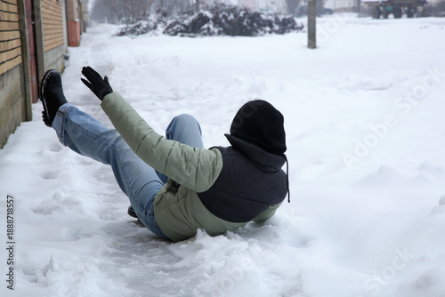 Winter Slip and Risk of Fall Accidents in Winter - a woman slips on an ice-covered road is a common winter hazard, leading to potential injuries