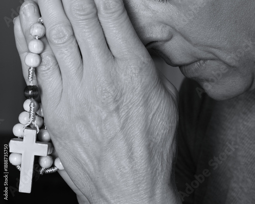 praying to god with hands showing her religious faith with God European woman praying with background with people stock photo stock image