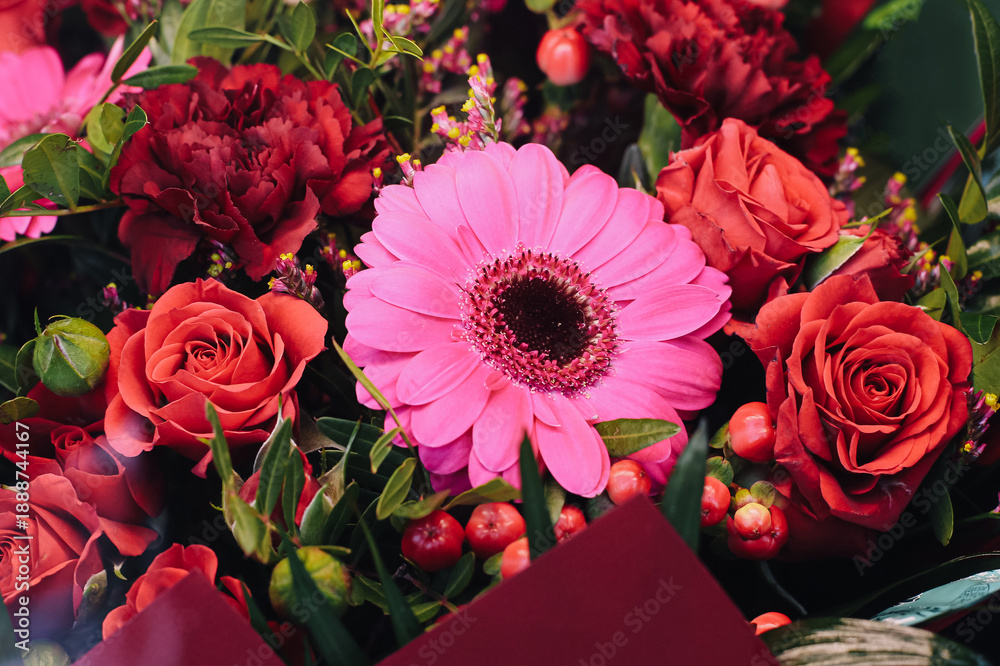 Fototapeta premium Colorful flower bouquet closeup with pink gerbera and red roses. Fresh floral arrangement detail. Romantic gift and celebration concept. Love and beauty in vibrant natural composition.