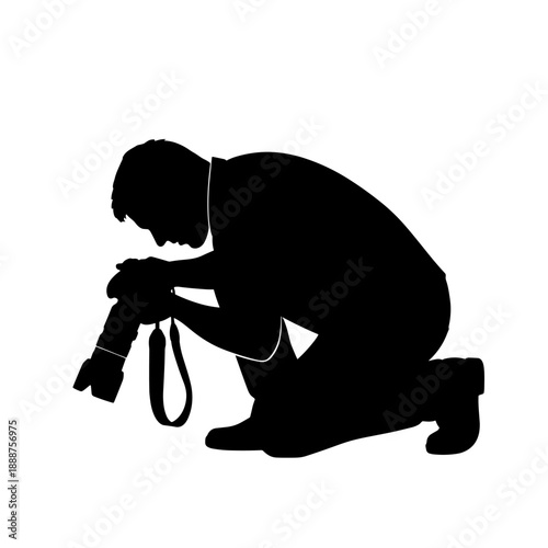 Photographer kneeling with camera in silhouette against white background  