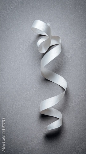 drape. A white ribbon curving downward against a minimalist gray background. wellbeing guides, coaching materials, designed for mental health education and mindfulness programs, clarifies learning.
