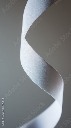 drape. A white ribbon curving downward against a minimalist gray background. wellbeing guides, coaching materials, designed for mental health education and mindfulness programs, clarifies learning.
