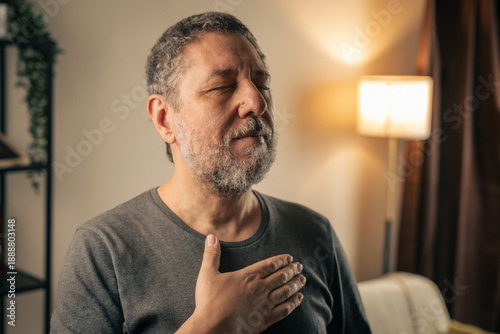 Canvas Print Mature man practicing mindful breathing at home in calm reflective moment