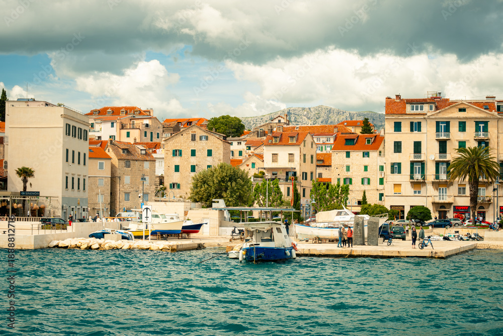Sunny Seaside Promenade, Coastal Harbor With Quaint Village, Gentle Waves Lap Against Historic Marina