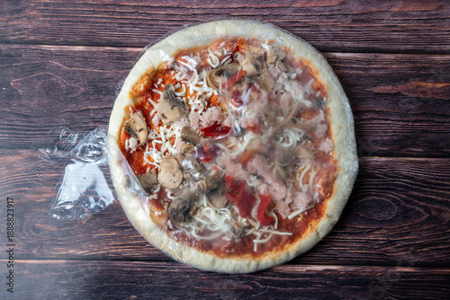 Frozen Pizza Wrapped In Plastic