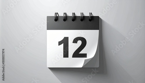 A calendar page with the number twelve on a white wall viewed straight on