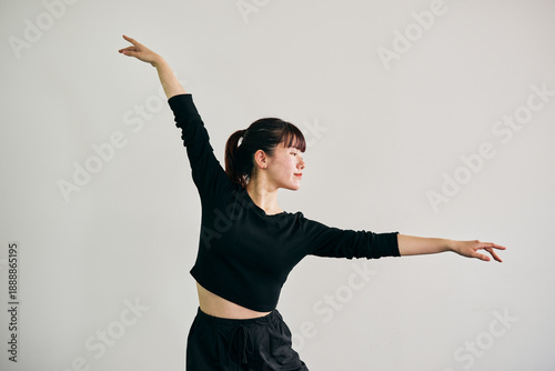 Canvas Print Young Japanese woman performing jazz dance with expressive arm movement