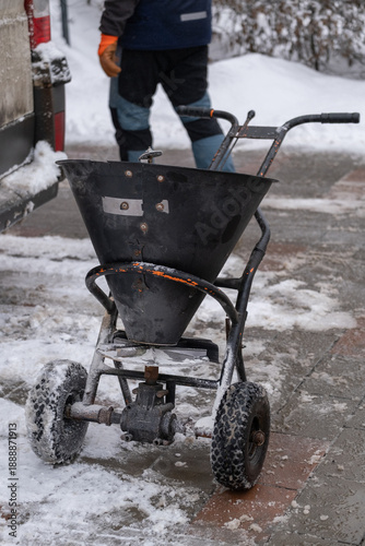 Fényképezés Salt spreader machine for winter sidewalk deicing in city