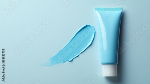 Light blue cosmetic product tube and smear on pastel background