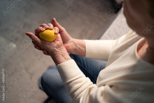 Картината върху платно Elder person hands squeezing stress ball improving rheumatoid arthritis