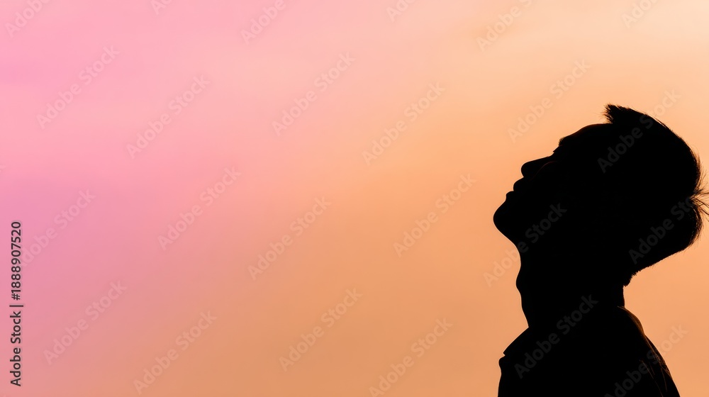 Naklejka premium backlight. Male silhouette against a vibrant sunrise sky with dramatic backlighting. travel magazines, destination branding, designed for travel destination branding, used by devops engineers.