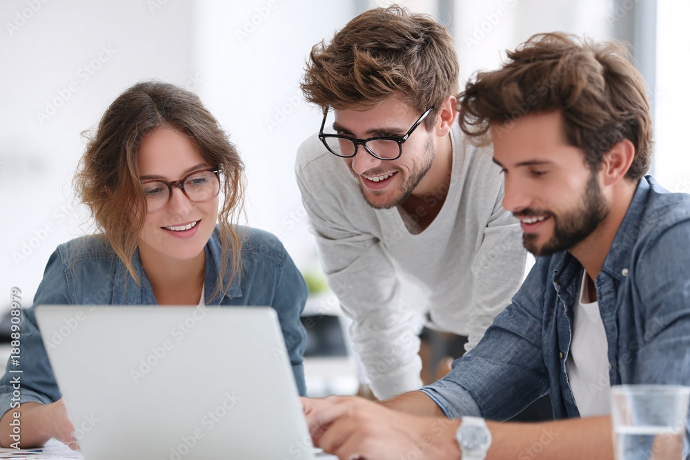 Fototapeta premium Diverse Young Professionals Collaborating On Laptop In Modern Office