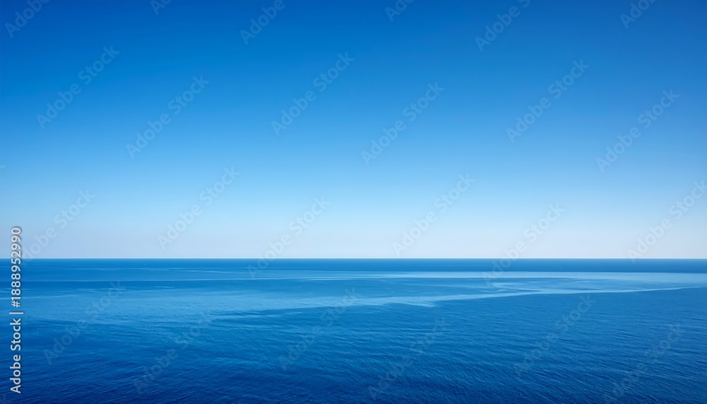 Obraz premium A serene vista showcases a vast, seamless expanse of the open ocean under a clear, gradient sky, a perfect display of nature's beauty