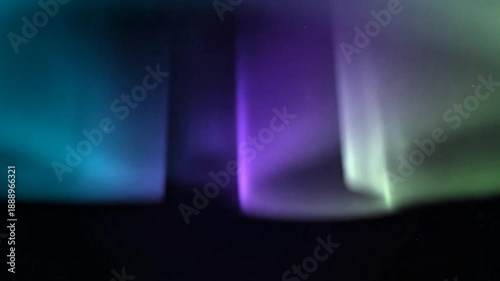 Cinematic wide shot of the Northern Lights dancing across the dark night sky