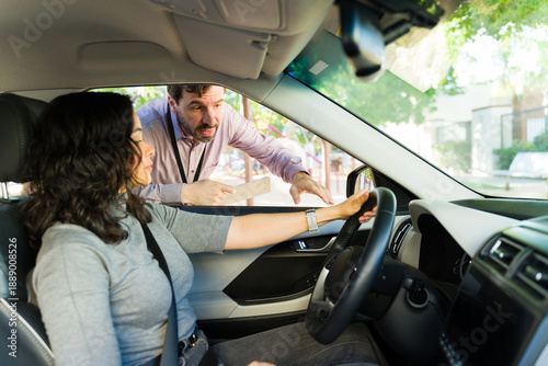 Photography Male driving instructor explaining road safety to adult student learning to mane