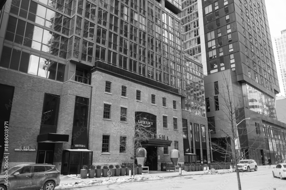 Fototapeta premium black and white view of facade entrance and sign of BISHA, a Luxury Collection Hotel, located at 80 Blue Jays Way, Toronto