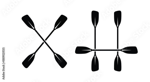 Two pairs of black kayak paddles crossed in symmetrical arrangements
